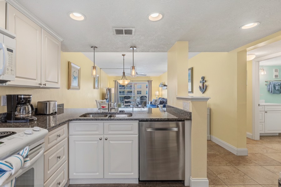 Kitchen peninsula with double sink looking toward the living area
