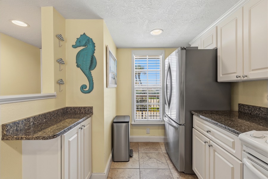 Bright kitchen with a teal seahorse wall accent