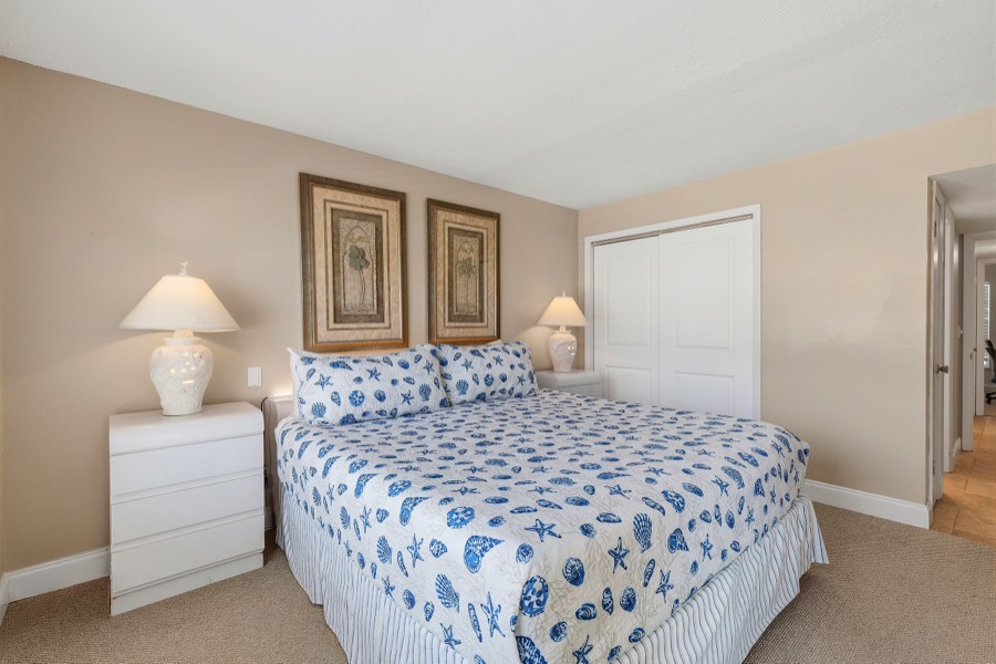 Primary bedroom showing closet doors and framed art