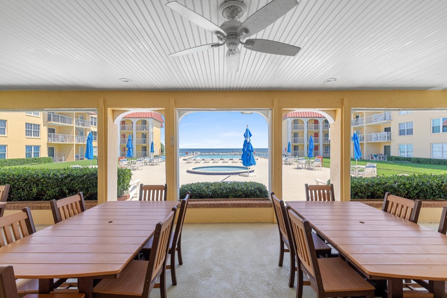 Covered oceanfront pavilion with picnic tables and ceiling fans