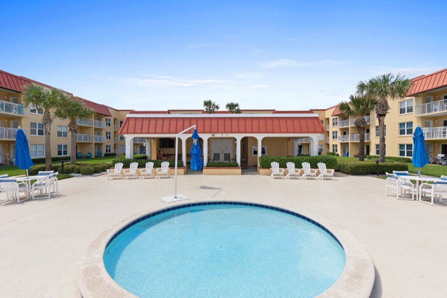 Round kiddie pool with cabana pavilion and lounge seating