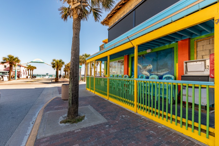 Colorful beachside restaurant patio with a sea-turtle mural