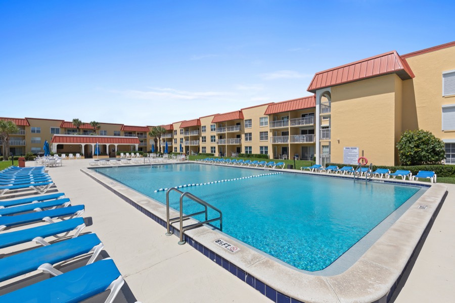 Lap pool with lane rope and rows of blue loungers