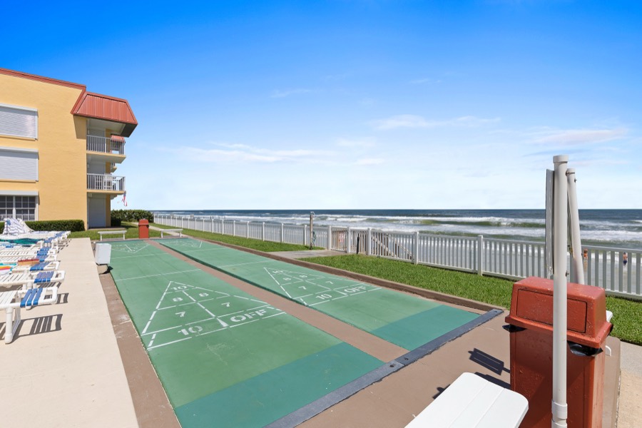 Shuffleboard courts beside the yellow condo building