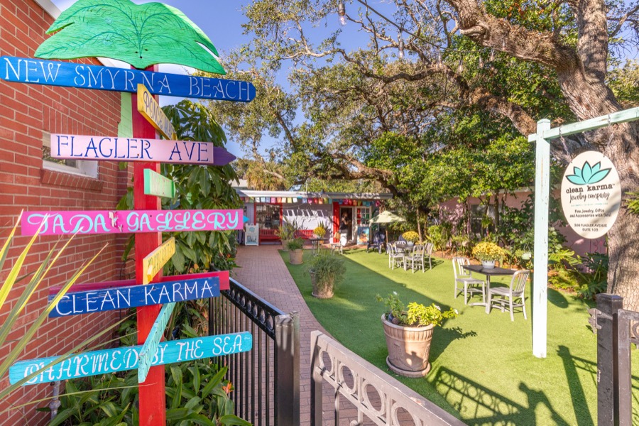 Colorful painted directional sign post for New Smyrna Beach attractions
