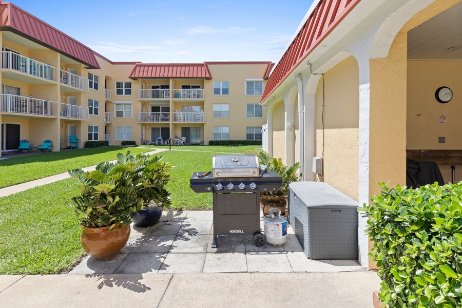 Community grilling station with a gas grill facing the courtyard