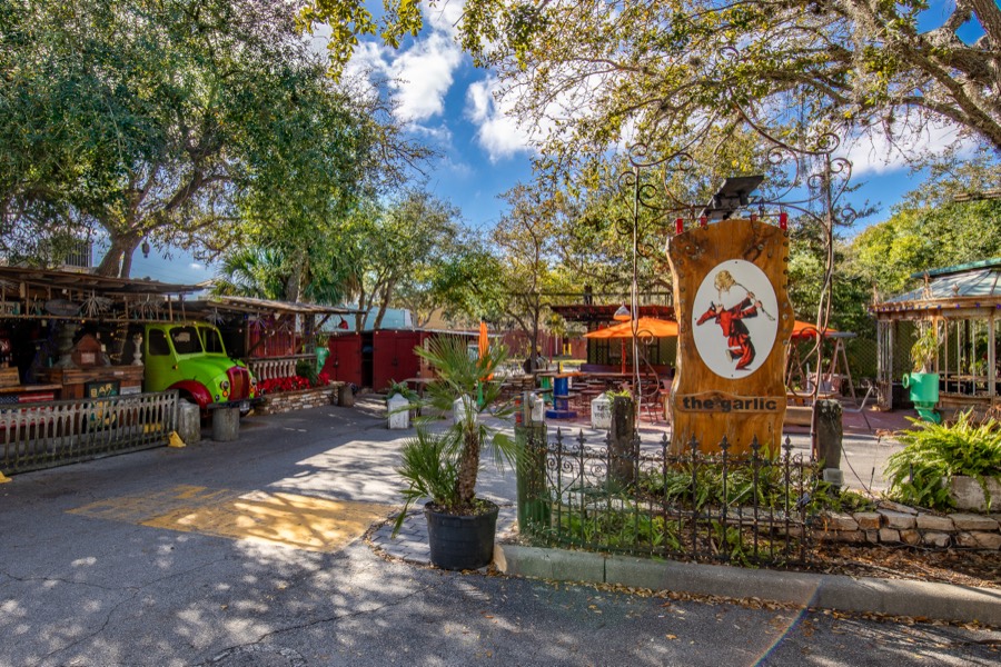 Courtyard entrance of The Garlic restaurant with a vintage green car